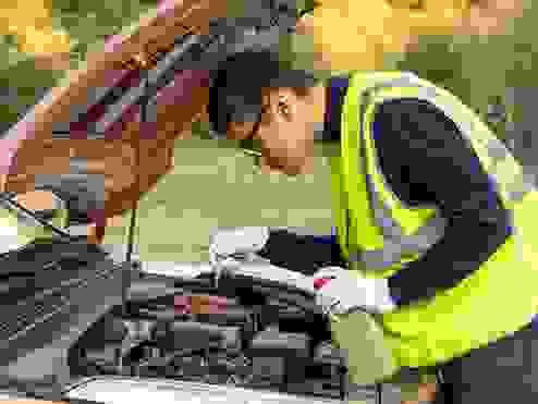 roadside assistance mechanic fixing an engine
